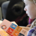 A girl reads a booklet with containing a list of the Sustainable Development Goals.