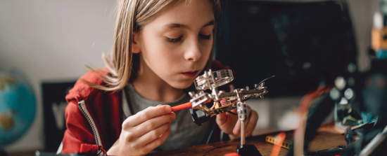 Girl inspecting mechanical parts